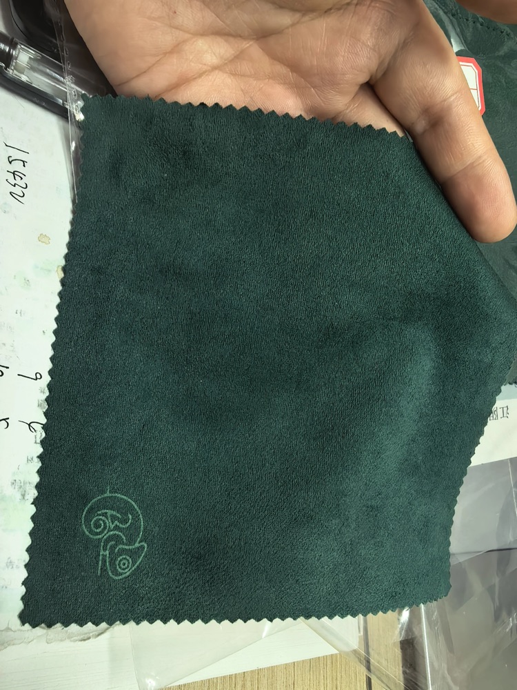 Green branded cloth with chameleon artwork